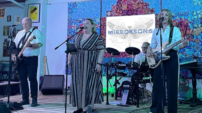 4-piece band MirrorSong on stage, drums, 2 guitars and a singer - 2 men and 2 women