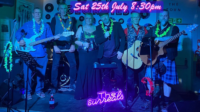 6-piece The Surreals posed on stage with their instruments